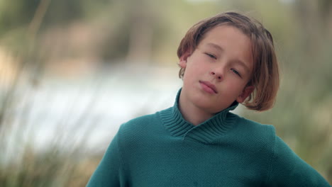outdoor portrait of a teenager sneezing because of allergy