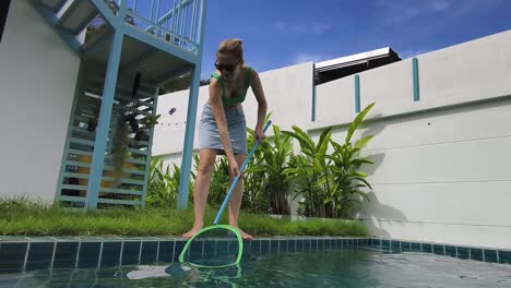 woman cleaning pool