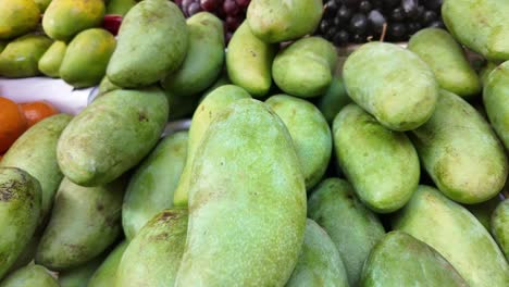 green mangoes at a market