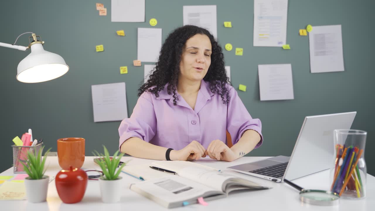 The Female student who finishes the homework is happy and peaceful.