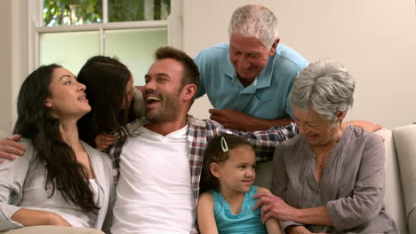 familia de varias generaciones sentadas juntos en el sofá