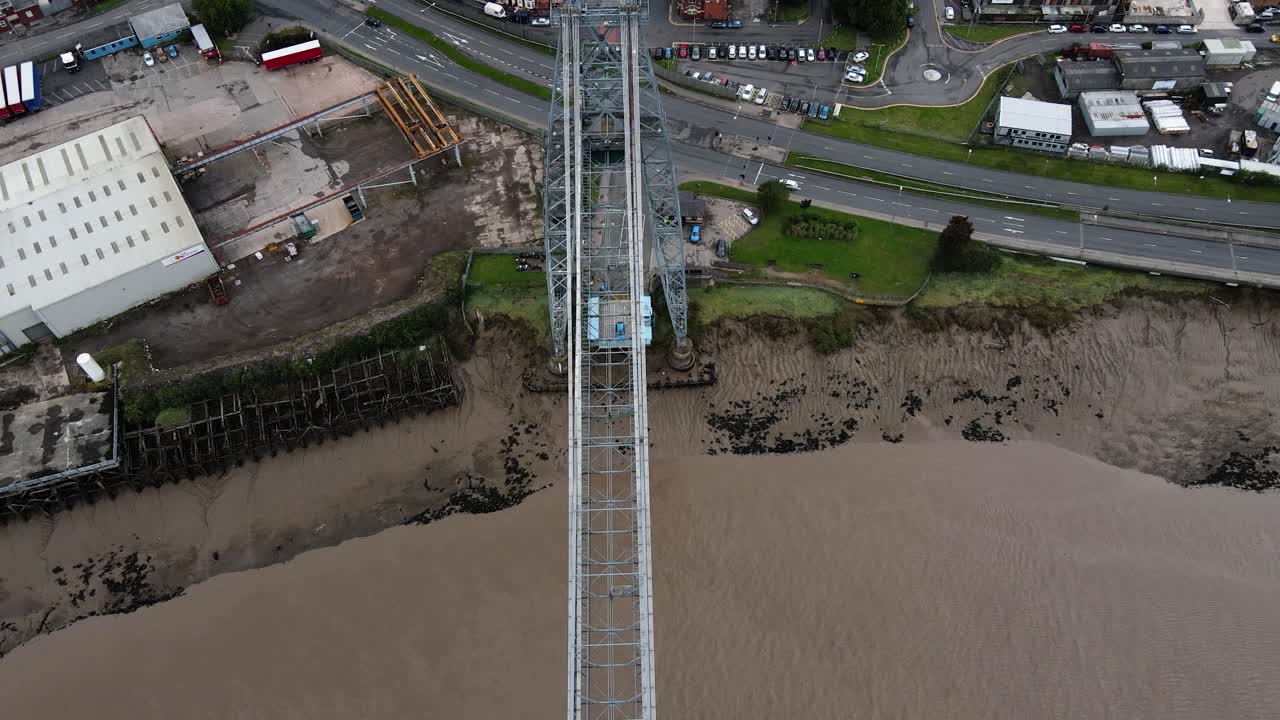 Newport Transporter Bridge aerial above River Usk South East Wales pull back birdseye