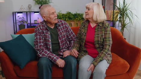 cheerful senior family couple grandparents man woman having pleasant loving conversation at home
