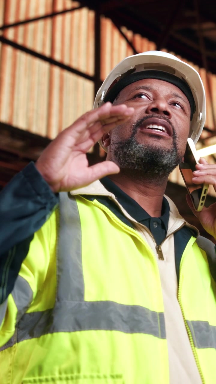 Construction Manager Talking on Smartphone in Warehouse