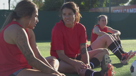 Female-Soccer-Team-Warming-Up-With-Stretches-During-Training-Before-Match