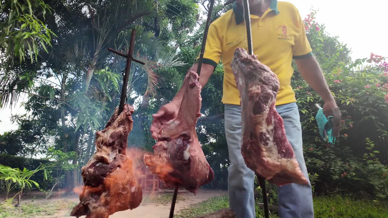Traditional meat roasting in Apure, Venezuela, outdoors with fire and smoke