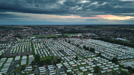 Aerial-view-of-Skegness-in-summer-sunset-drone-video:-holiday-park,-beach,-caravans,-and-sea