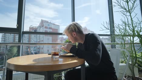 man eating lunch in a modern rooftop cafe