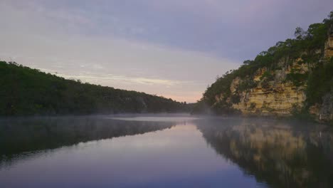 mist rising from a calm lake in the morning