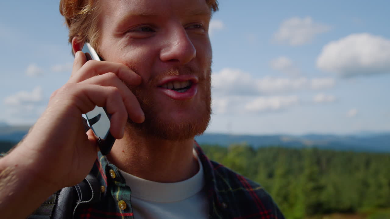 Man talking on smartphone in mountains