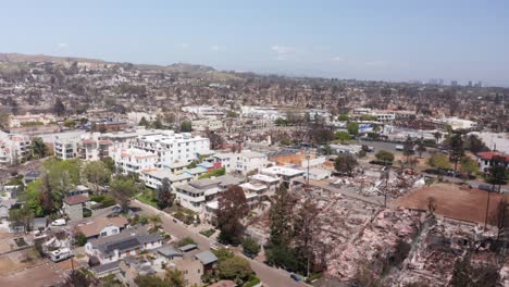 wide aerial panning shot of sunset blvd. in downtown pacific palisades after the palisades fire in los angeles, california. 4k
