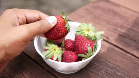 ripe red strawberries in a bowl on table
