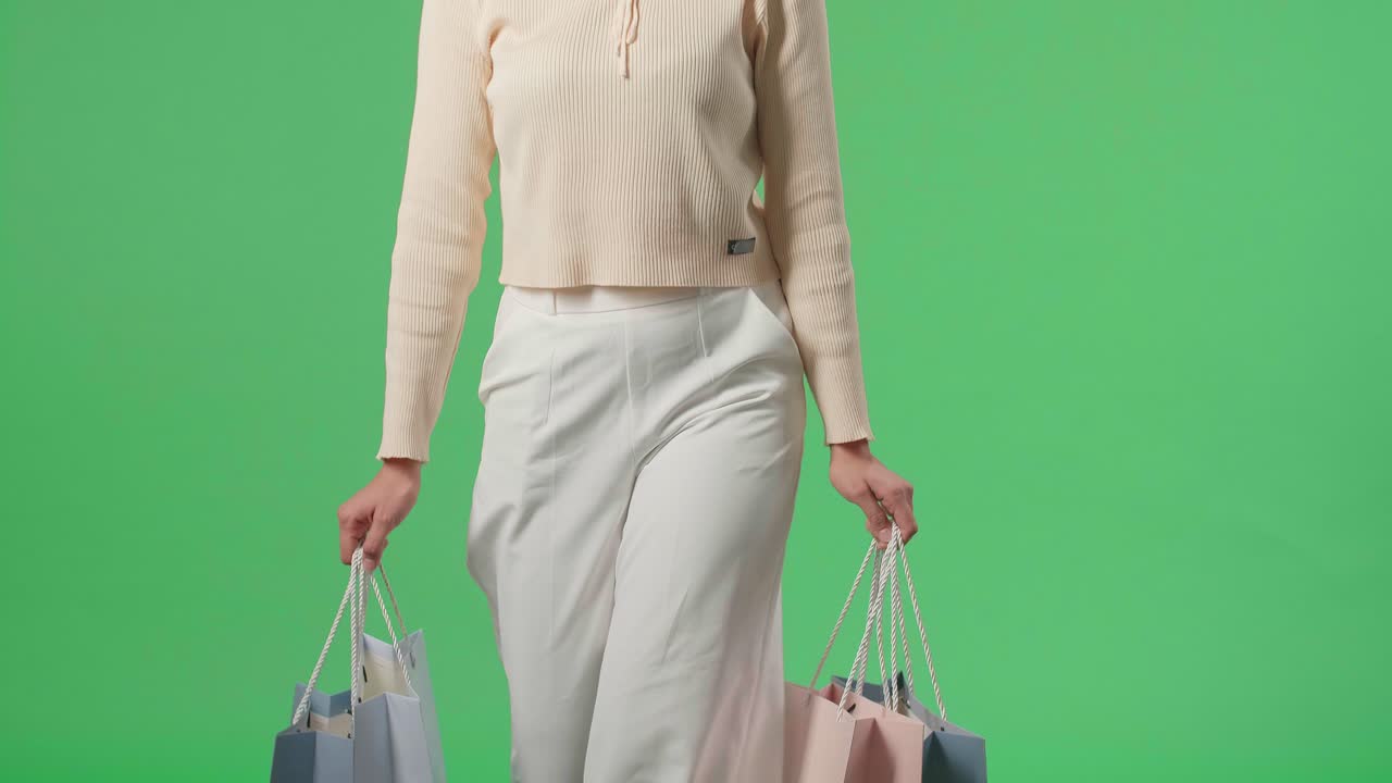 Asian Shopping Woman With Shopping Bags Smile And Walking In Front Of Green Screen