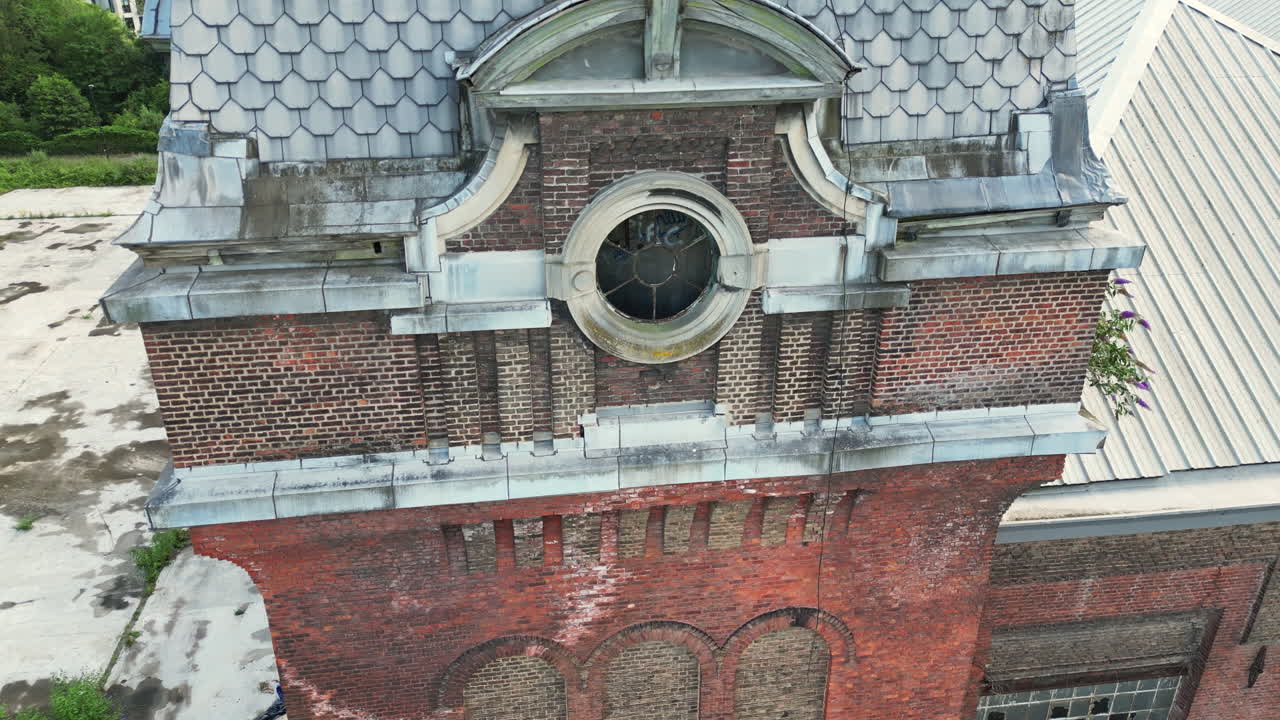Closed Up Aerial of Old Abandoned Brick Building With Round Window in Ghent