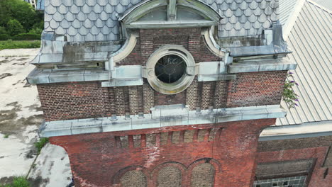 closed up aerial of old abandoned brick building with round window in ghent