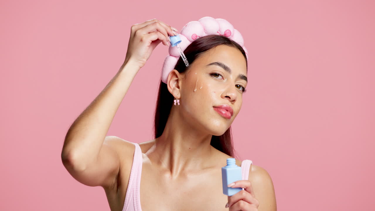 Woman applying serum to her face