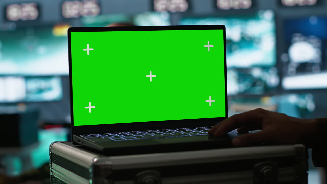 Military dispatcher managing communications networks, looking at screens