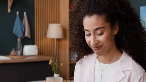 young woman drinking a beverage at home