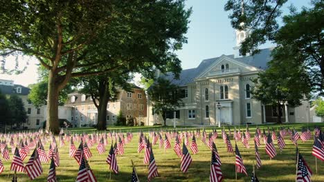 Separation-of-church-and-state-theme,-American-flags-juxtaposed-with-historic-church-and-steeple-in-United-State-of-America