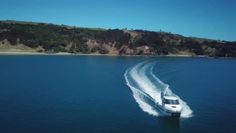 aerial, flying in front of a speed boat travelling towards the camera till it gets off the side of the camera, 4k