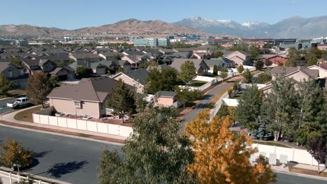 suburban neighborhood nestled below the wasatch front rocky mountains in lehi, utah - pull back aerial flyover