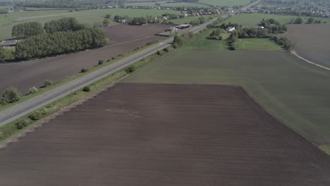 drone aerial view above british a580 east lancs highway in rural agricultural countryside