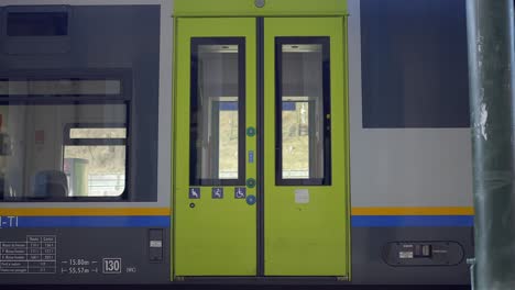 static shot of train green door closing automatically to start