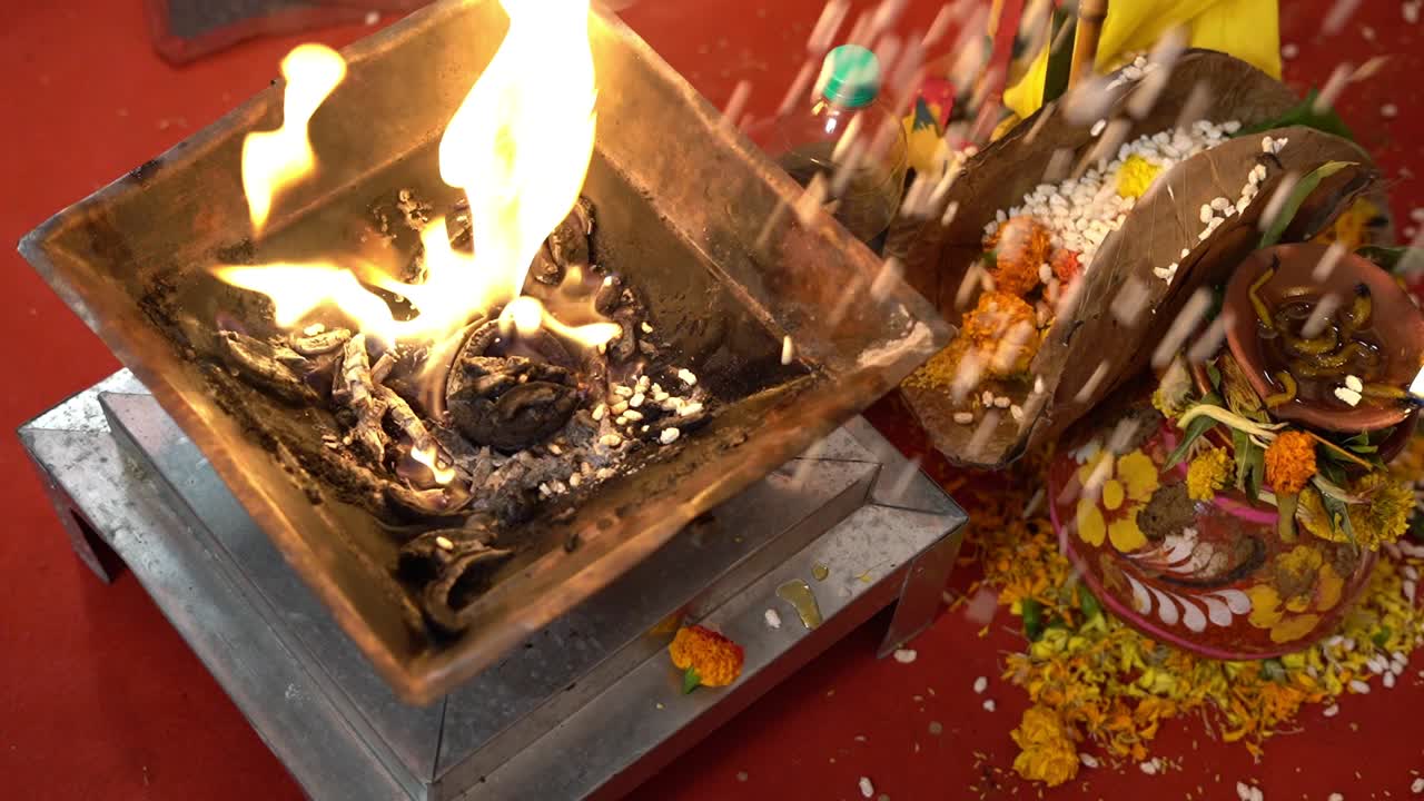 Hindu wedding fire or Yagna during Hindu religious ceremony in India. Slow motion shot of a yagna