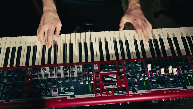 Close Up of keyboard Player Hands Playing Rock Music with keyboard at the Concert in studio, rehearsal room, macro play on synthesizer.