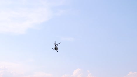 closeup of a private helicopter fly on blue sky by day slow motion