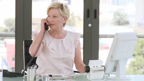 Professional-businesswoman-working-at-her-desk