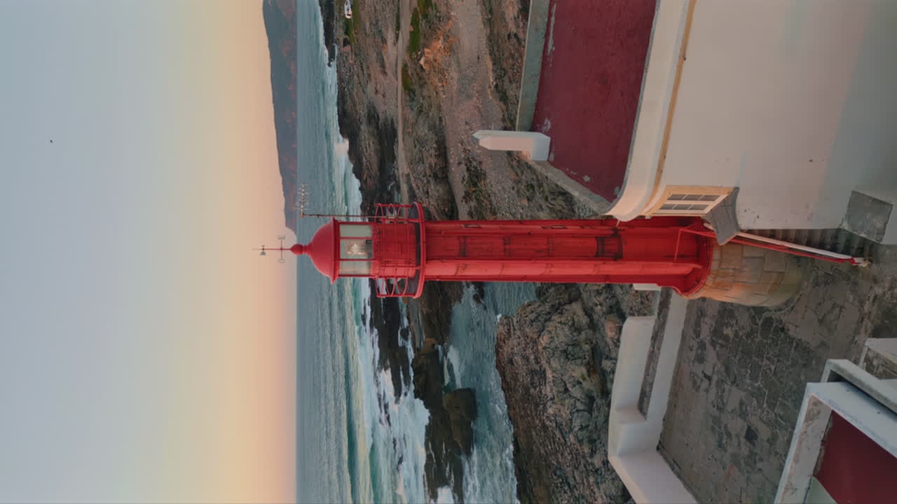 Aerial view beautiful beacon standing on stony seaside at summer twilight.