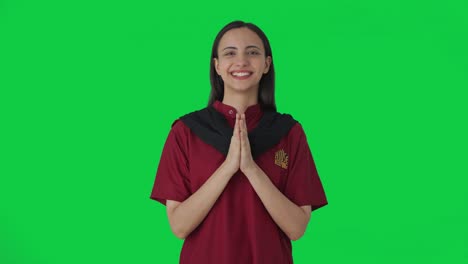 happy indian female housekeeper welcoming guests green screen