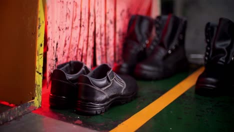 shoes moving through stages of production on conveyor belt during manufacturing