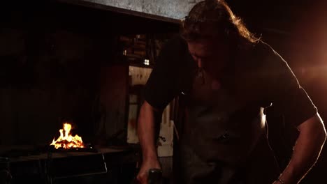 blacksmith working on a iron rod