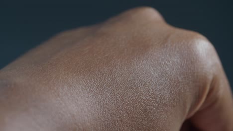 applying moisturizing cream to a hand