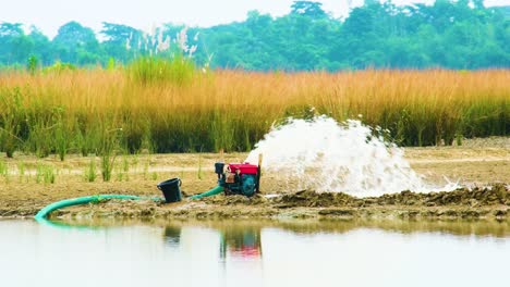 local irrigation power pump pumping water on agriculture fields for irrigation in bangladesh during morning