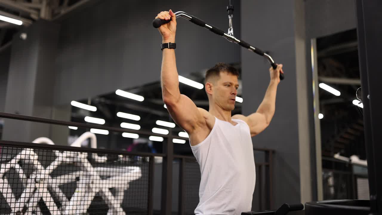 Man doing lat pulldown exercise in gym