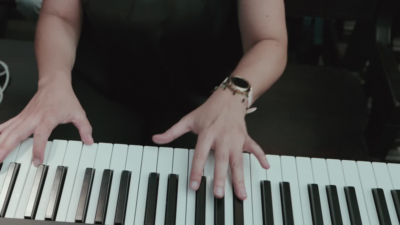 Close up of hands playing piano keys with focus on elegant movement and artistic expression