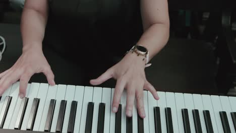 close up of hands playing piano keys with focus on elegant movement and artistic expression