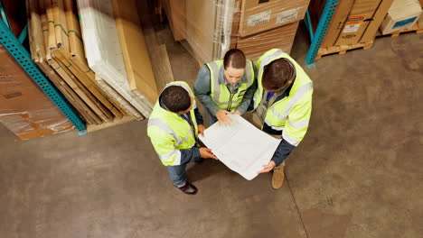 warehouse workers reviewing blueprint