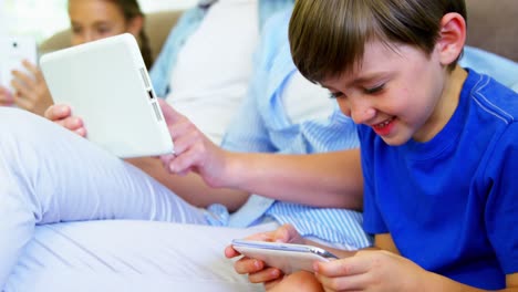 Niño-Sentado-Con-Su-Familia-Usando-El-Teléfono-Móvil