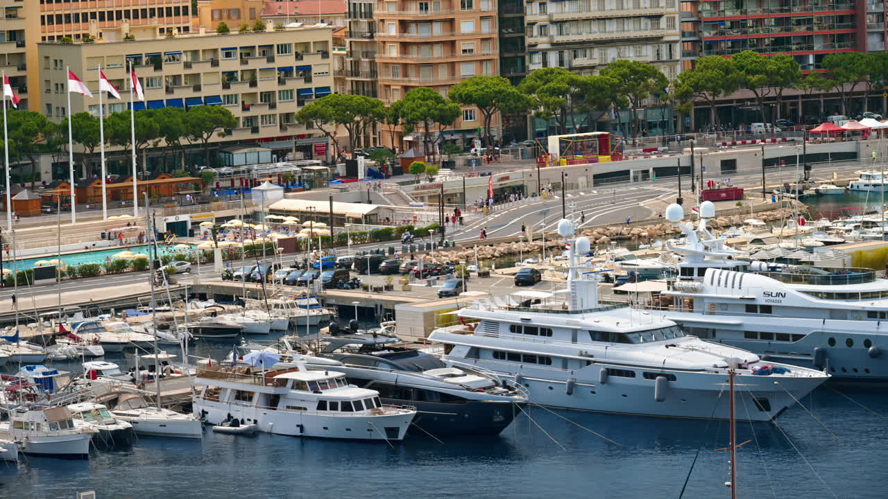 View of boats docked in the Monaco Marina with the skyline of the city on the background