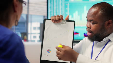 insurance broker explaining financial plans to senior couple in a modern office