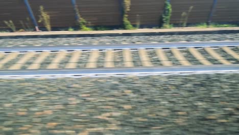 view of railway tracks from moving train