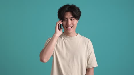 handsome asian man talking by phone