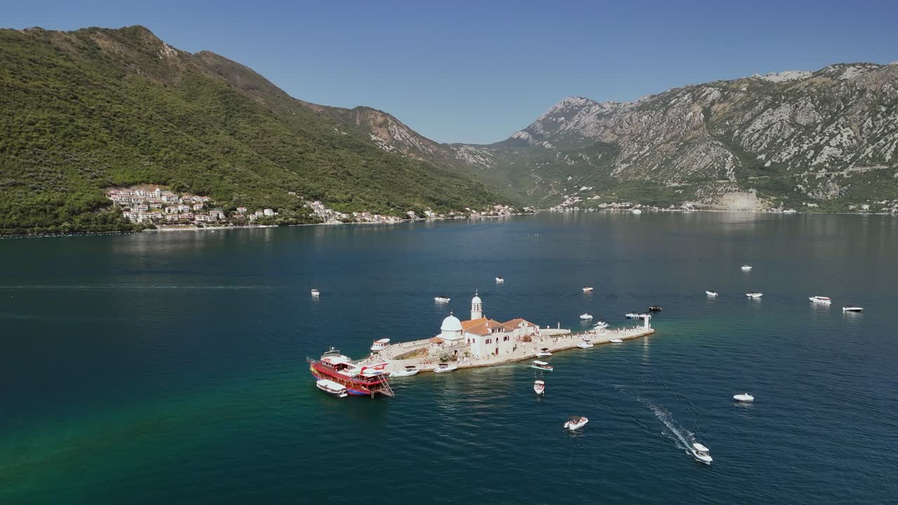 Aerial orbits Our Lady of the Rocks artificial island in Montenegro