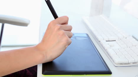 graphic designer working on digitizer at her desk