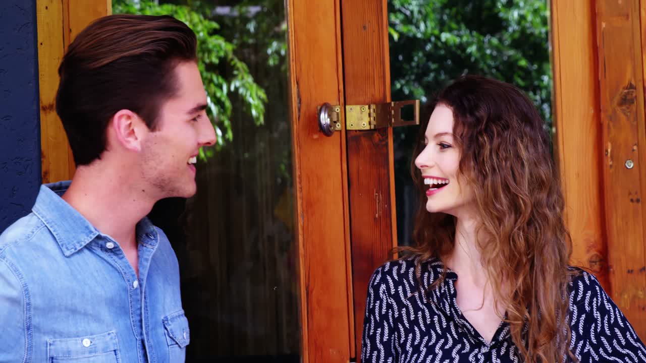 Couple standing at the entrance of caf&Atilde;&copy;