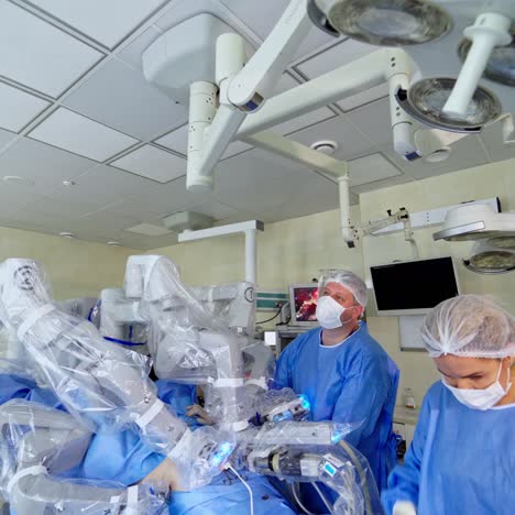 modern surgical room with medical equipment. operating process with surgical robot. doctor and nurse control the robotic surgery. innovative medicine concept